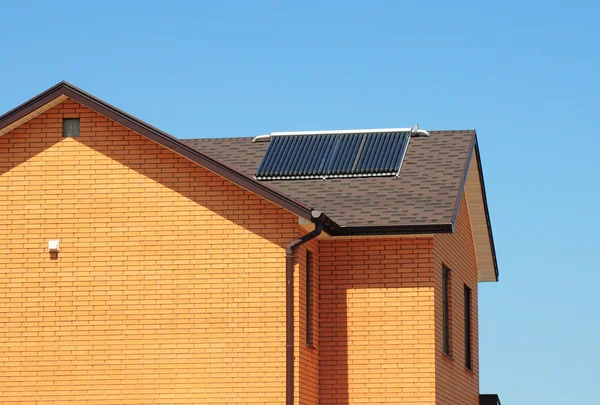 Vacuum collectors - solar water heating system,vents, rain gutter on bitumen roof