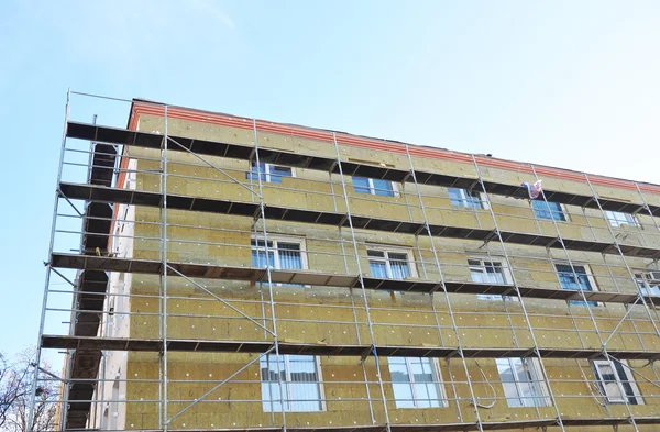 Exterior house wall heat insulation with mineral wool, building under construction. The more heat flow resistance your insulation provides, the lower your heating and cooling costs.
