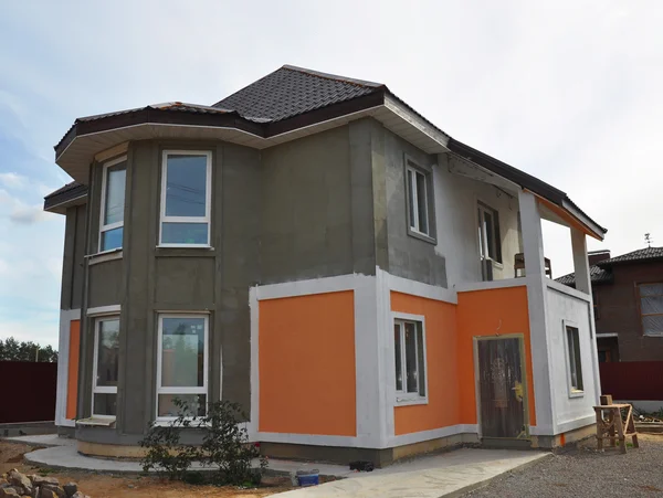 Painting and Plastering  Exterior House Wall. Facade Thermal Insulation and Painting Works During Exterior Renovations