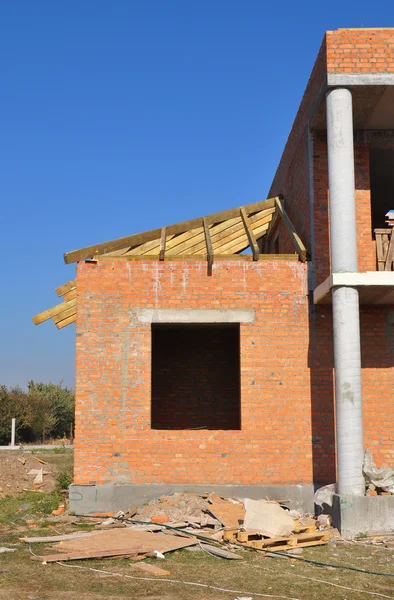 New brick building house construction with doorway columns, wind