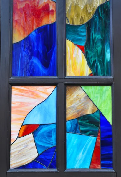 Colorful  multicolored stained glass window with irregular block pattern in a hue of blue