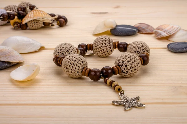 Handmade bracelet crochet beads with pendant starfish on a woode