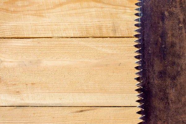 Rusty saw on the wooden table