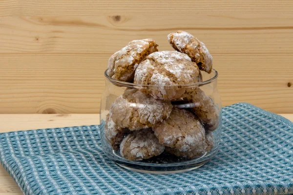 Italian cookies in glass jar on wooden table