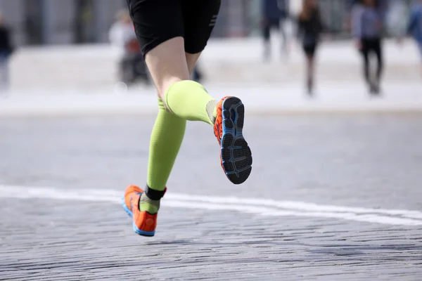 Feet running distance athlete on the stone pavement