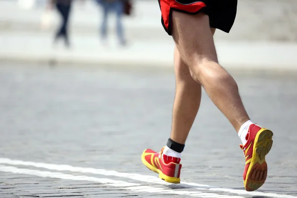Feet running distance athlete on the stone pavement