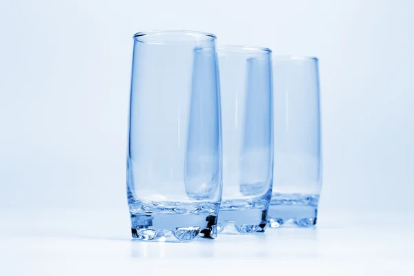 Three blue transparent glass with a light blue background