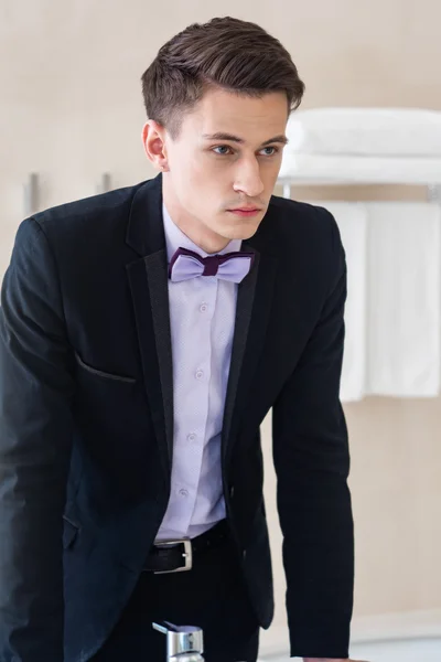 Businessman sitting in a chair looking at the mirror