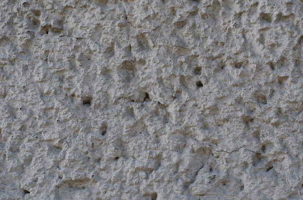 Background of a gray stucco coated and painted exterior, rough cast of cement and concrete wall texture, decorative coating