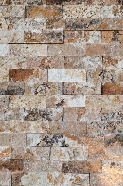 Background of a stone wall cladding texture, brown stone bricks