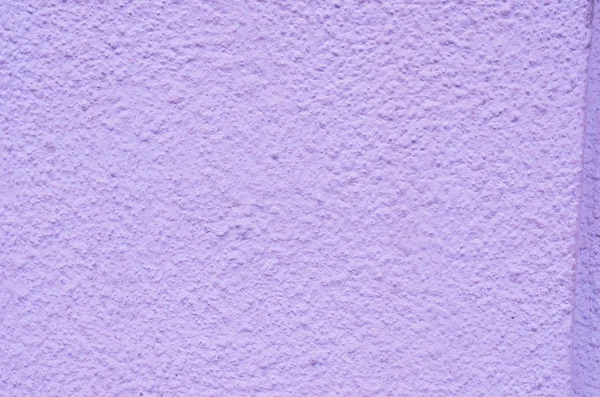 Background of a dark pink stucco coated and painted exterior, rough cast of cement and concrete wall texture, decorative coating