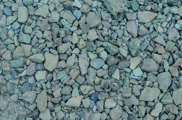 Background of gray gravel and crushed stone, construction material for road