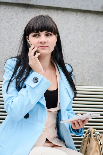 Dark haired girl speaking on the phone