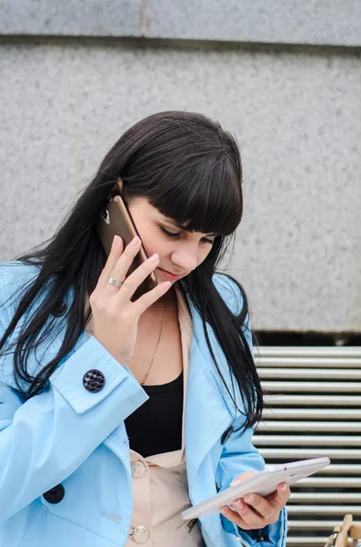 Dark haired girl speaking on the phone