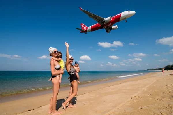 Family enjoying with landing plane on beach