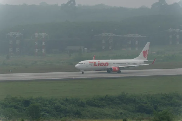 Thai lion air airline taxi in haze at krabi airport