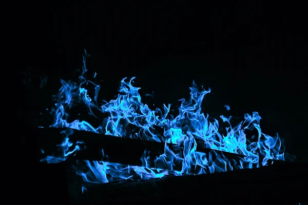 Bright fire texture on black background. Blue gas flame