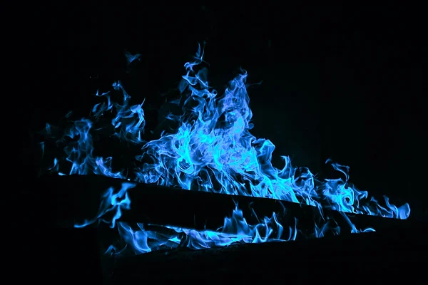 Bright fire texture on black background. Blue gas flame