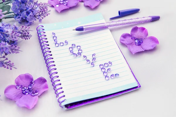 Office supplies business women. Notebook and pen. Some office stuff on a white background. Accessories on the table. Purple lavender color interior details.