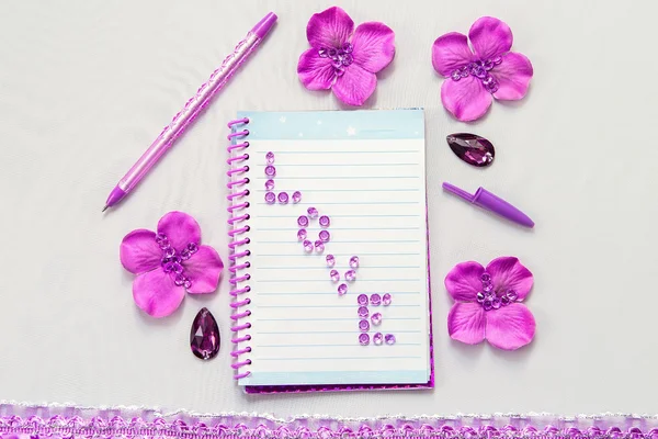 Office supplies business women. Notebook and pen. Some office stuff on a white background. Accessories on the table. Purple pink color interior details.