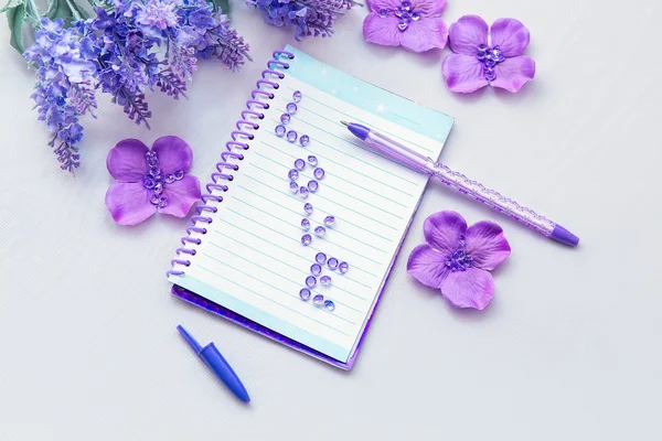 Office supplies business women. Notebook and pen. Some office stuff on a white background. Accessories on the table. Purple lavender color interior details.