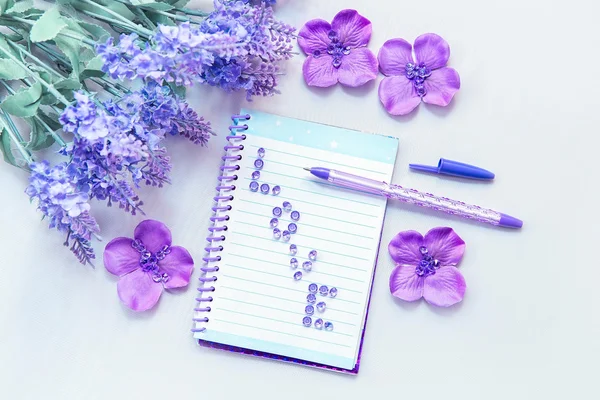 Office supplies business women. Notebook and pen. Some office stuff on a white background. Accessories on the table. Purple lavender color interior details.