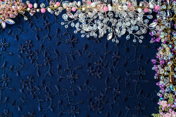 Beautiful shiny background. Crystals, beads, wire, twigs, wedding accessories collected on dark fabric