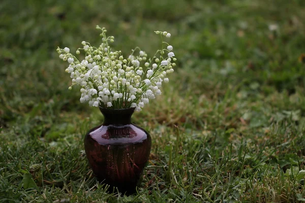 Vase with lilies of the valley