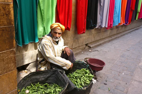 Moroccan street seller of green peas, Morroco  Fez 20 february 2014