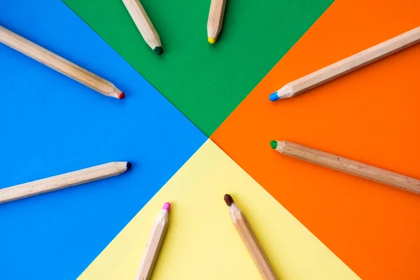 Colorful picture of wooden pencils circled around edges of rainbow colors.
