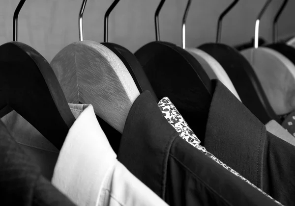 Shirts and jackets in wardrobe isolated closeup