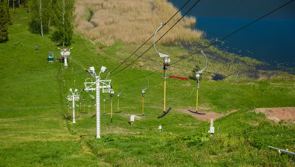 Funicular at sports base on the backdrop of green hills and lakes