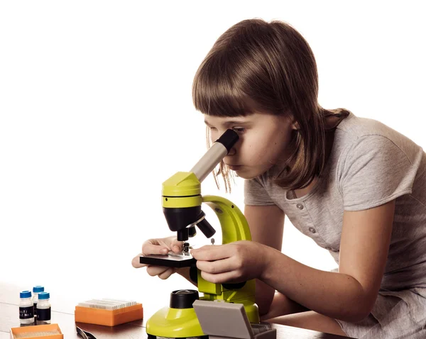Little girl  study with microscope on white background