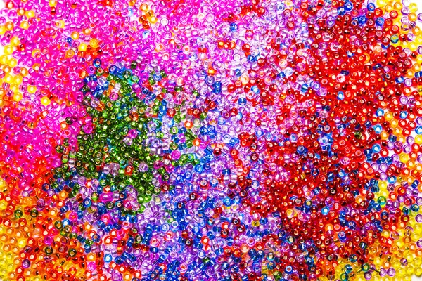 Background of sparkling multicolored glass beads. Saturated color picture for greeting card or background