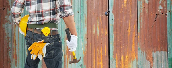 Builder handyman with construction tools.