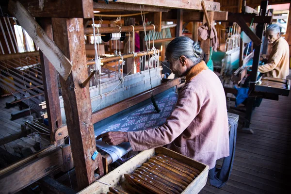 An unidentified Burmese woman weaving clothe