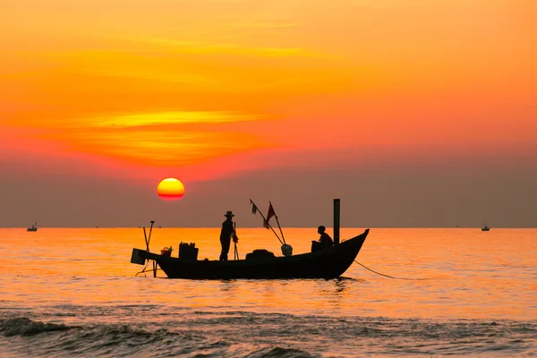 Fishermen on boat in sunrise in Hai Ly, Nam Dinh