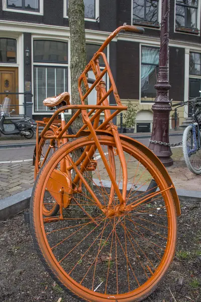 Fanny orange bike on the street of Amsterdam