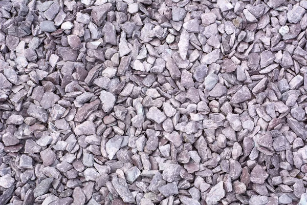 Lilac stones on the ground as background