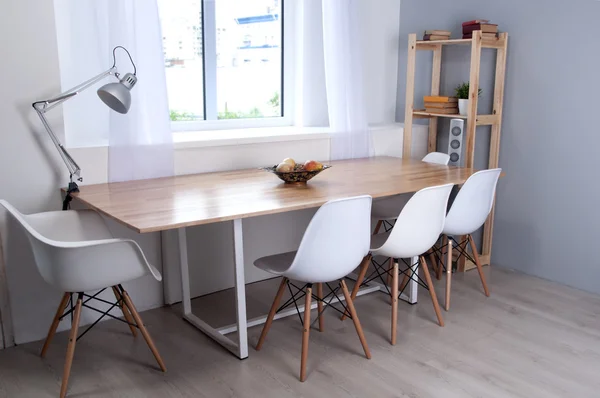 Part of interior with white chairs and table for negotiations