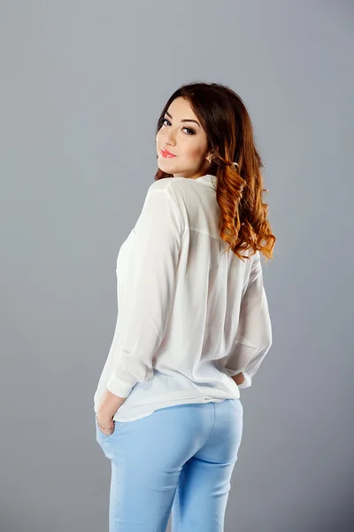 Portrait of a model dressed in blue jeans and white shirt.