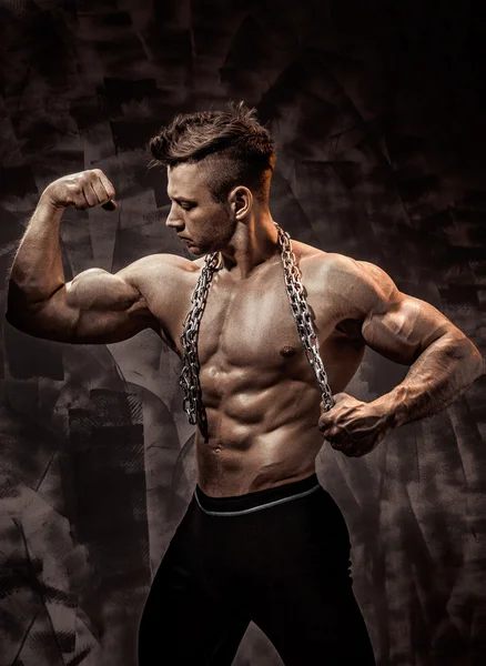The Perfect male body - Awesome bodybuilder posing. Hold a chain