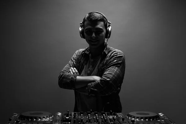 Silhouette of young man, dj with mixer. Back and white photo.