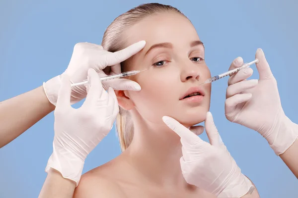 Portrait of young Caucasian woman getting cosmetic injection