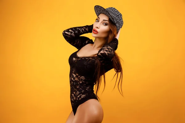 Sexy model with long hair in fashion cap and lace body