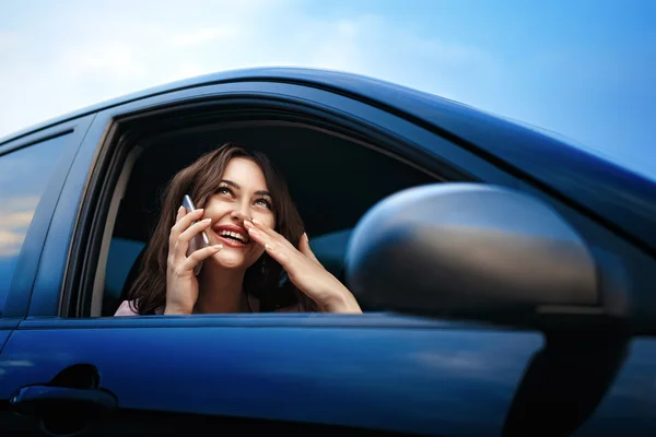 Smiling beautiful woman speaking by the phone