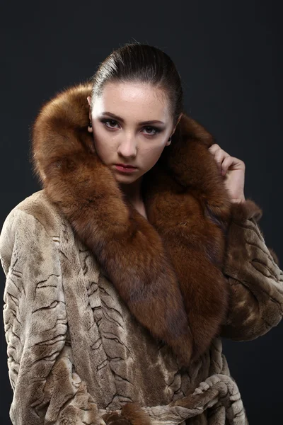 Portrait of a seductive lady in fur coat