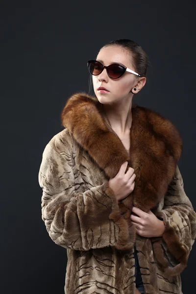 Portrait of a seductive lady in fur coat