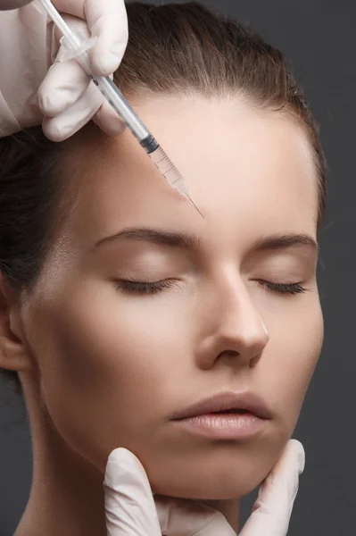 Portrait of young Caucasian woman getting cosmetic injection