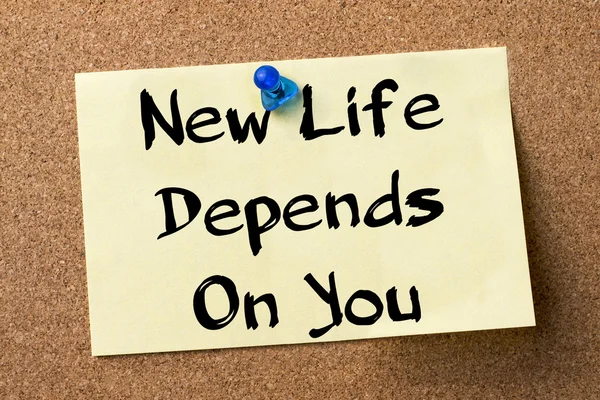New Life Depends On You - adhesive label pinned on bulletin boar